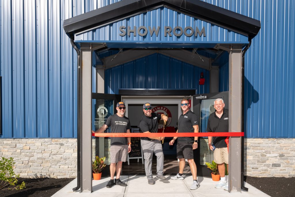 Fimbel owners cut ribbon at Grand Opening ceremony.